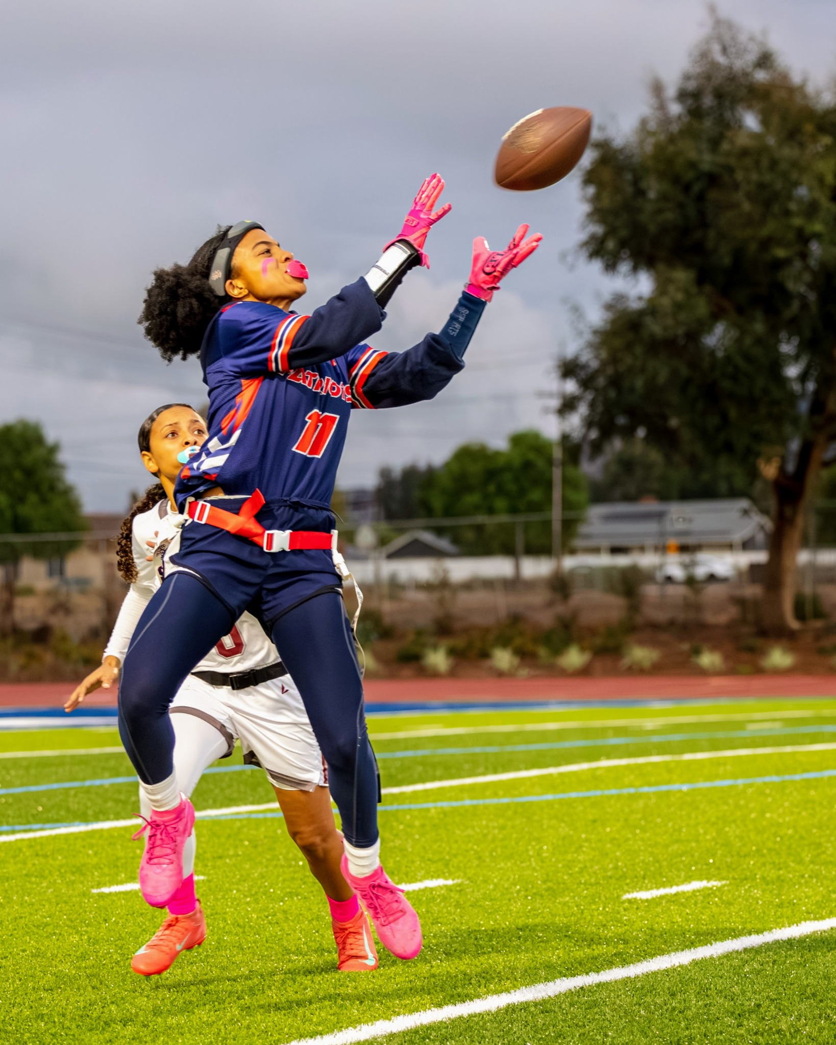 Flag football player reaching for a pass