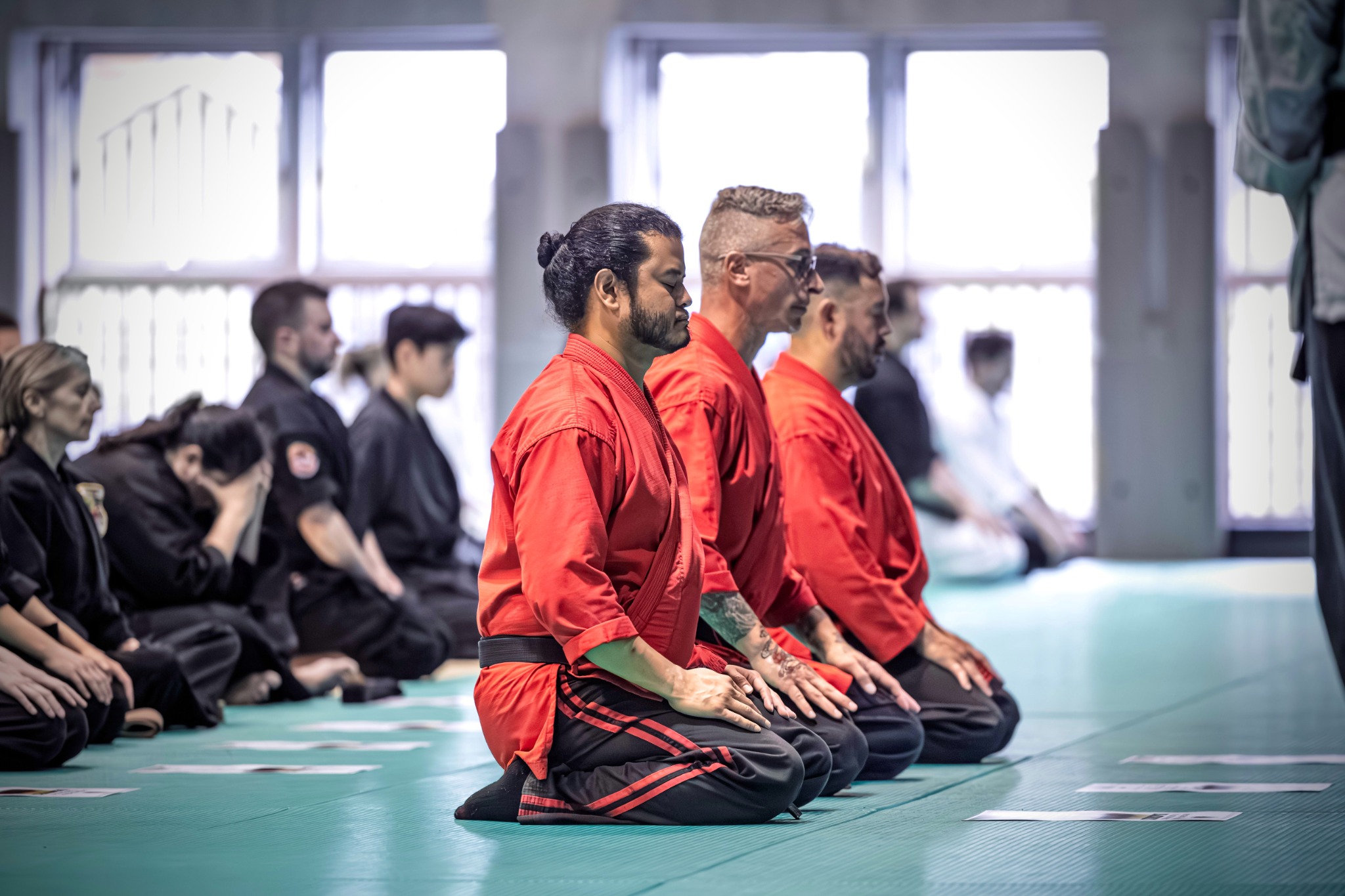 Martial artists seated during a ceremony